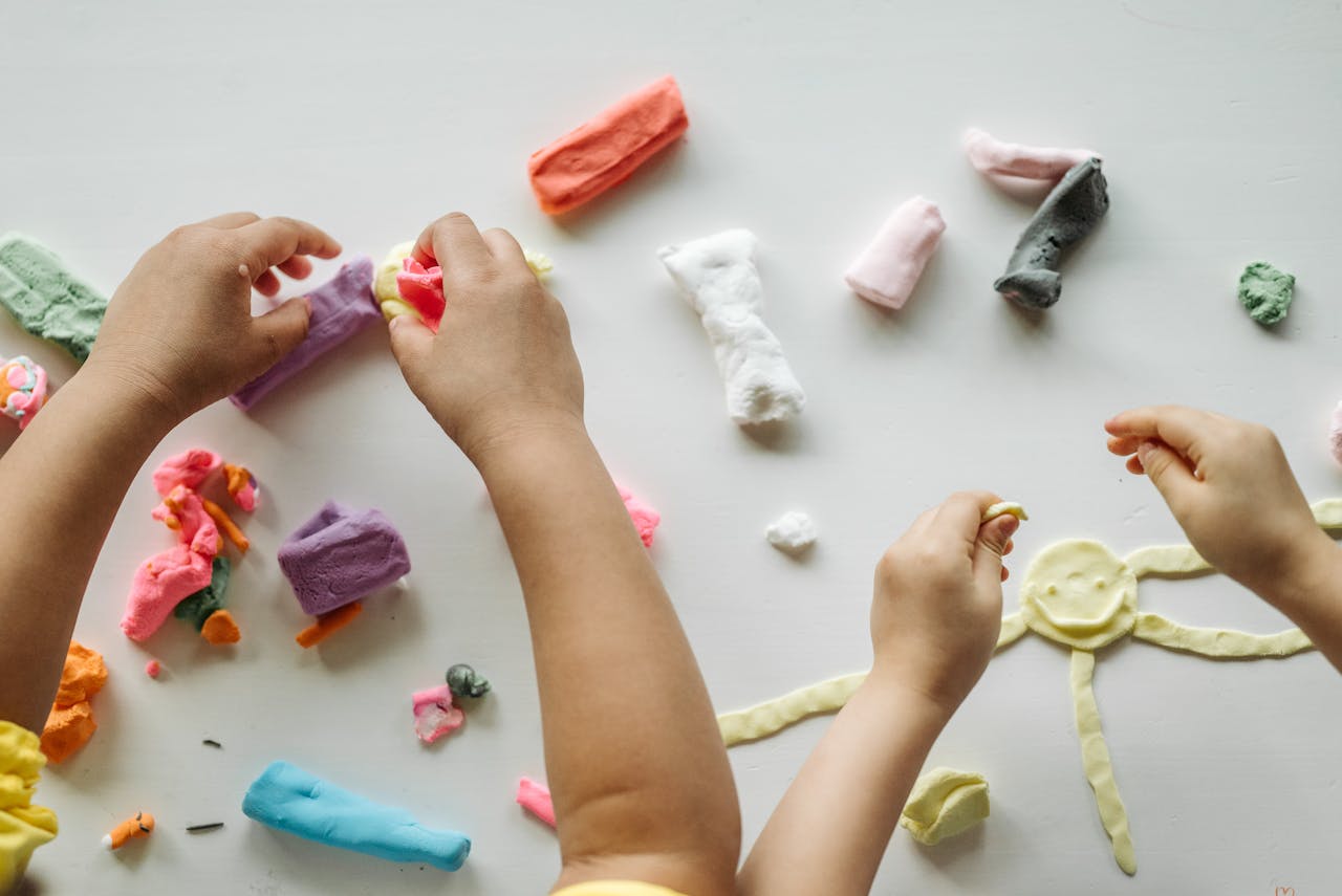 Children playing with colorful play-doh at Loving Littles Daycare