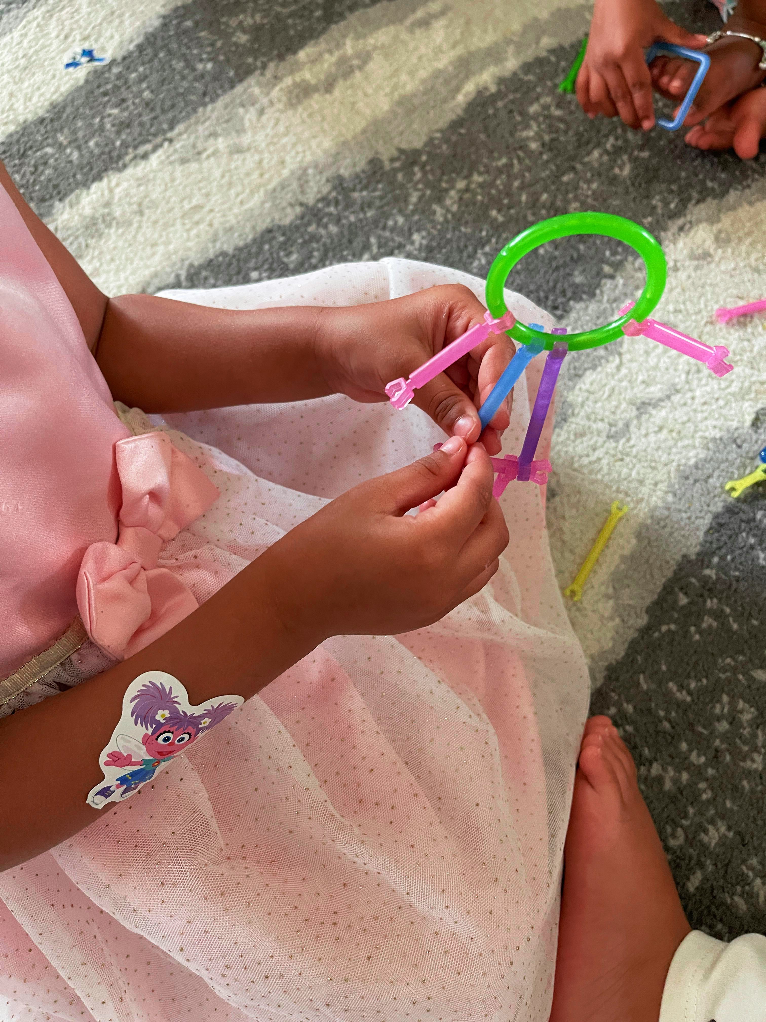 Child assembling building sticks at Loving Littles Daycare